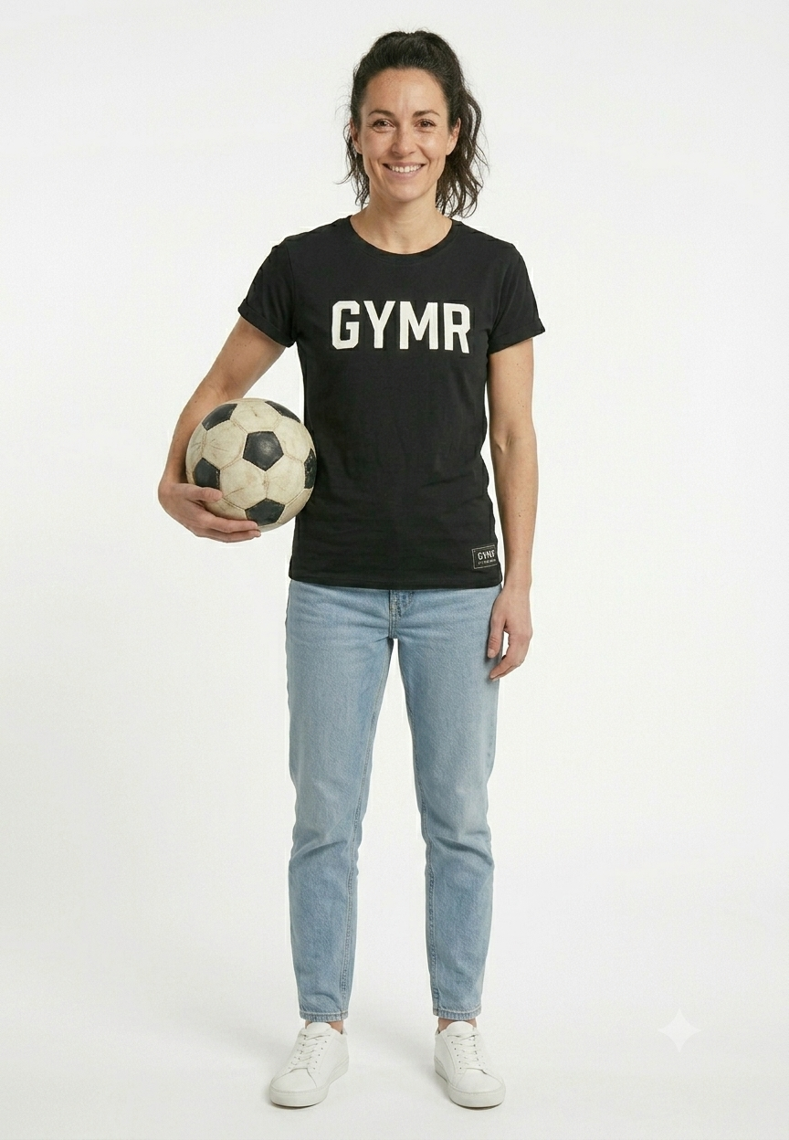 Person wearing a black t-shirt with 'GYMR' text, holding a soccer ball, on a white background