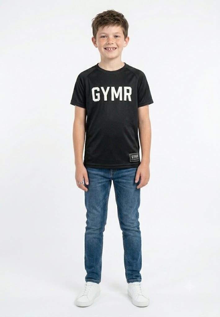 Child wearing a black 'GYMR' t-shirt and blue jeans on a white background