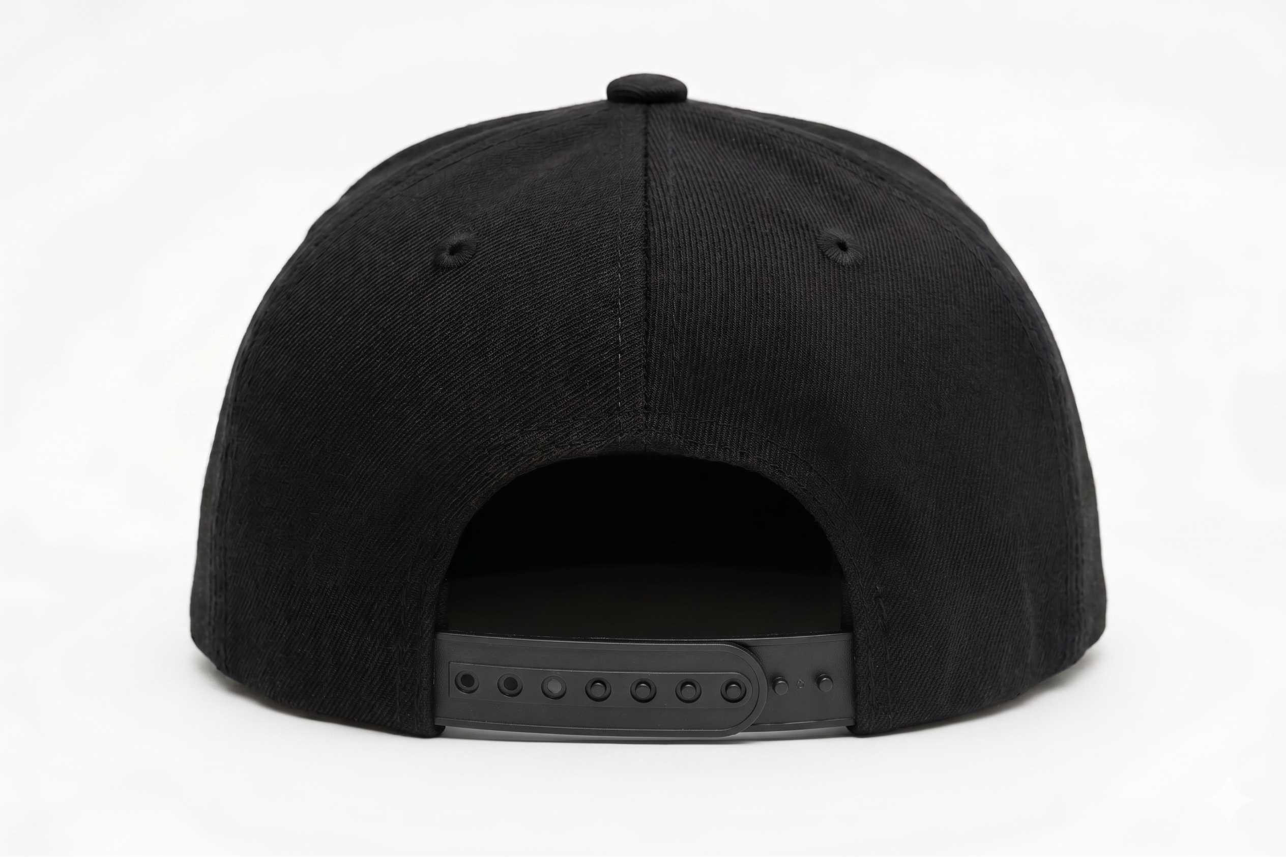 Back view of a structured black snapback hat showcasing the adjustable black plastic snap closure, isolated on a clean white background.