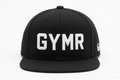 Front view of a structured black snapback hat featuring thick white embroidered GYMR text on the front panels, isolated on a clean white background.